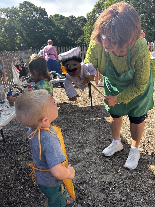 child cutting shapes out of paper