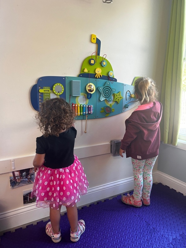 child cutting shapes out of paper