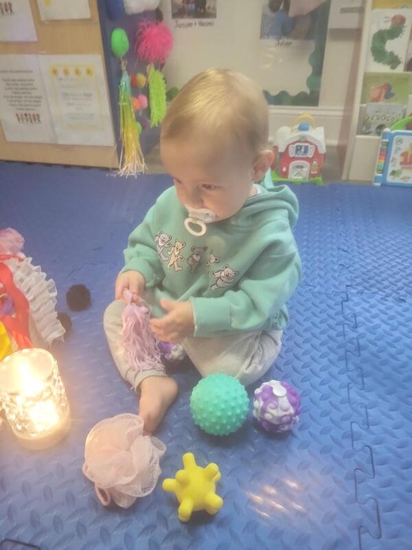 Kids looking through books while sitting on blanket outside