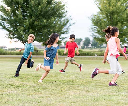 children running around in a circle outside