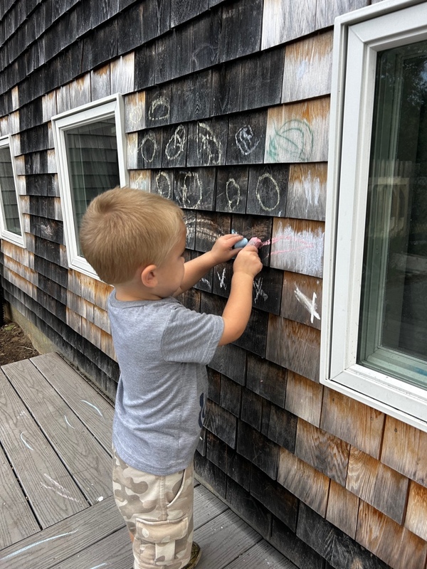 child giggling with hand over her mouth