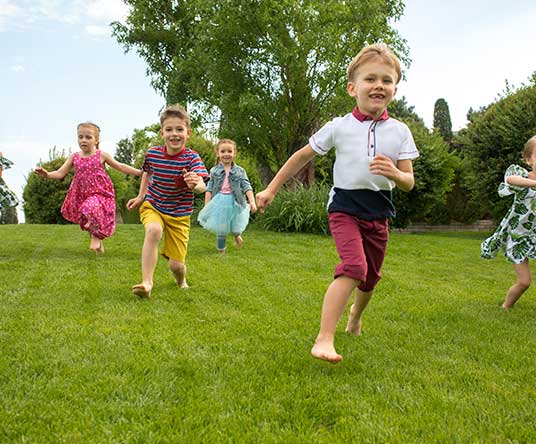 kids running through grass